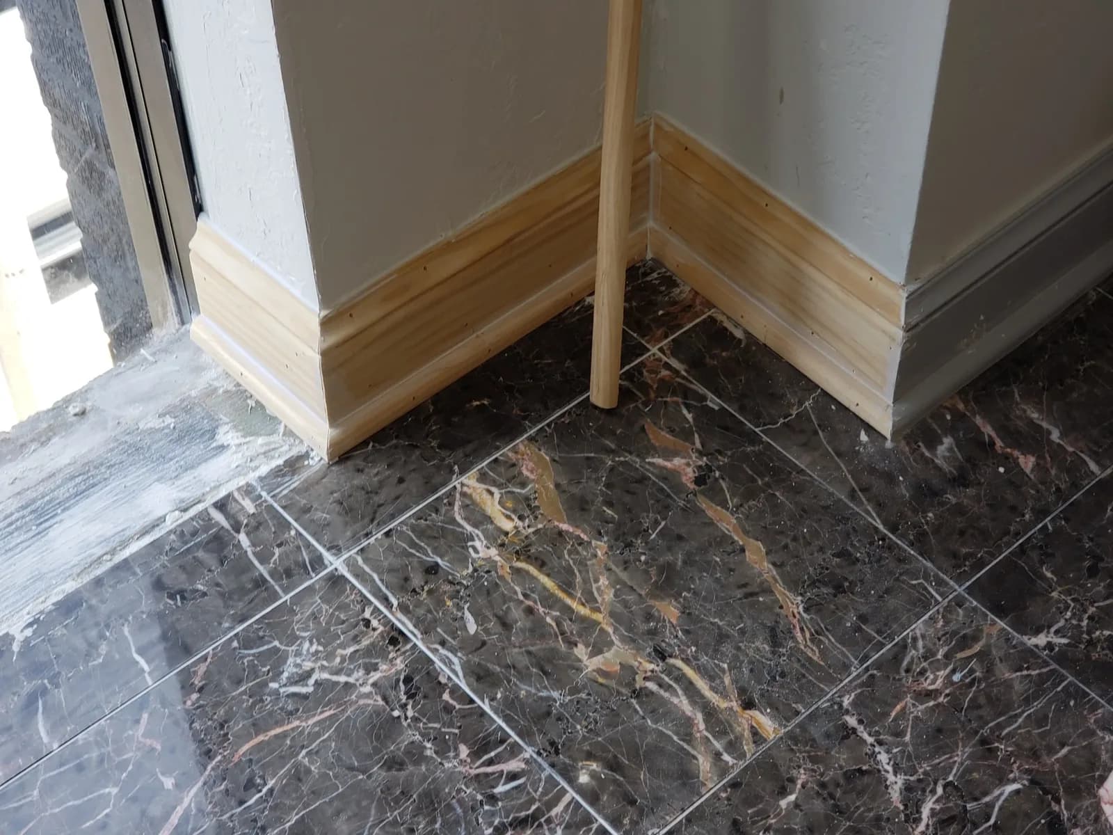 Marble tile floor and fresh trim in a finished renovation